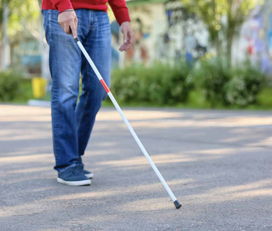 a blind person is walking with a cane in the street